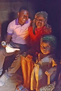 Patrick, a seminarian visiting with a family.