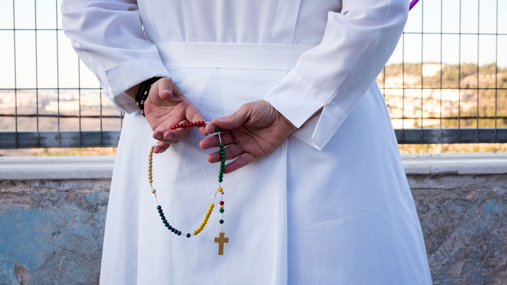 A nun holds a rosary in the Holy Land