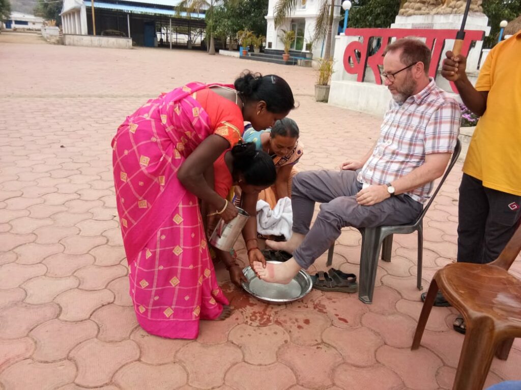 A Sister washes Fr Gerry's feet
