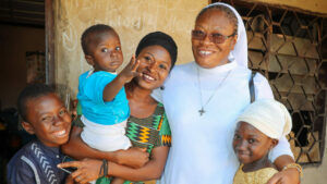 Sister Veronica with a young family in Nigeria